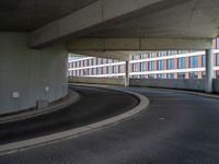 a car is driving on the highway through an underground parking garage area in a city