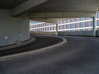 a car is driving on the highway through an underground parking garage area in a city