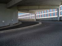 a car is driving on the highway through an underground parking garage area in a city