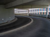 a car is driving on the highway through an underground parking garage area in a city