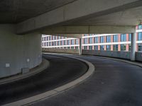 a car is driving on the highway through an underground parking garage area in a city