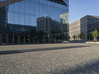 the reflection on a building that is outside has buildings reflected by it's glass