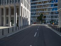 the empty street with bicycles parked in front of the buildings has a sign that says the library on it