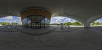 a 360 view of a building and several pillars with trees in the background on top