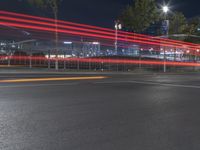 a street in front of some buildings has some red streaks on it as if a car turns a corner