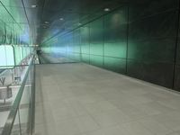 a corridor with grey tiles and glass walling in an industrial building in the city