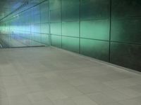 a corridor with grey tiles and glass walling in an industrial building in the city