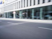 a blurry photo of a street with a man on a skateboard in the background