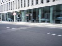 a blurry photo of a street with a man on a skateboard in the background