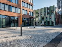 some buildings with lots of windows and a traffic sign that is outside a large brick building