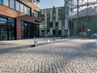 some buildings with lots of windows and a traffic sign that is outside a large brick building