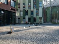 some buildings with lots of windows and a traffic sign that is outside a large brick building