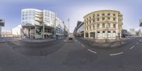 a fisheye lens shot of a city street with a traffic signal and a building