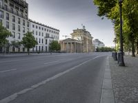 a street in the middle of an empty city street with no cars on it and buildings along