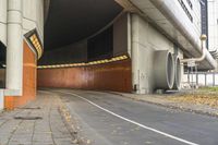 an underpass on the side of a road leading to the city street and tunnel