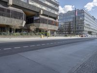 a street view near many skyscrapers, along with a bicycle on the sidewalk and several cars on the road