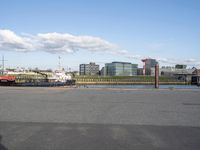 a boat is docked at the dock, under the cloudy sky, next to a building