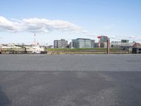 a boat is docked at the dock, under the cloudy sky, next to a building