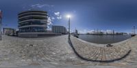 this is an image of a circular shot of some buildings near a river thames by itself