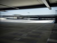 motion blurs shot of empty parking lots under the roof of an overpass building