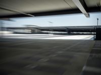 motion blurs shot of empty parking lots under the roof of an overpass building