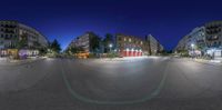 a fish - eye lens view of a city street at night in the darktime