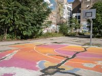 an old basketball court painted with colorful street art outside the city buildings in europe / europe