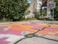 an old basketball court painted with colorful street art outside the city buildings in europe / europe