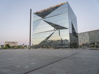 the reflection of an architecture in a modern building windowed across the square is seen