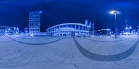 a 360 lens photo shows a wide angle of the building and walkways that are reflecting the light