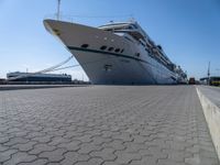 the large white cruise ship has a huge bow and a green stripe on it's side