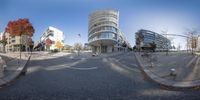 two fisheye panoramic shots show the intersection of a city street with two buildings