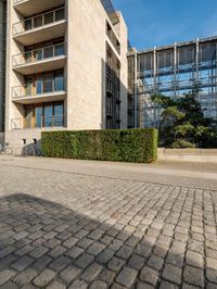 the exterior of a building with a bike in the foreground and a building on either side