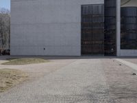 there is a red fire hydrant in front of a gray building with a gate