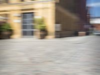 the view from a perspective of a man riding a skateboard on the street, using a blurry image