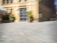 the view from a perspective of a man riding a skateboard on the street, using a blurry image