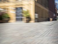 the view from a perspective of a man riding a skateboard on the street, using a blurry image