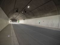 there is a man standing in the middle of a tunnel that looks like it has a car going through