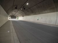 there is a man standing in the middle of a tunnel that looks like it has a car going through