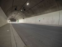 there is a man standing in the middle of a tunnel that looks like it has a car going through