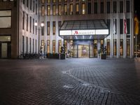 a building is lit up with a lit sign that says marriott in white letters on the front