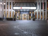 a building is lit up with a lit sign that says marriott in white letters on the front