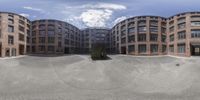 an outdoor photo shows the outside of buildings and skateboards in the foreground with the image to be spherical