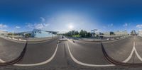 360 - degree photograph of bike riders crossing over one lane at same time on city street