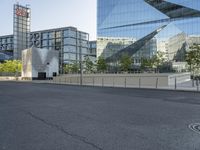 a long road leads into the center of a city and has glass buildings behind it