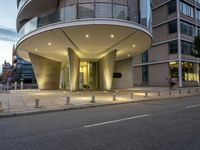 an image of the modern building with curved facade and balconies on the sidewalk