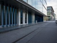 an airport parking lot with a plane parked outside the terminal building of it and a boat out in the harbor