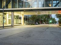 this is an empty city street at night with buildings and traffic lights on the side