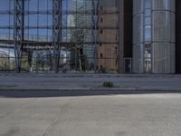 a boy is playing with a soccer ball in front of a building with a reflection of a tree