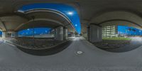 a panorama of the highway in an airport at night showing a parking area and bridge